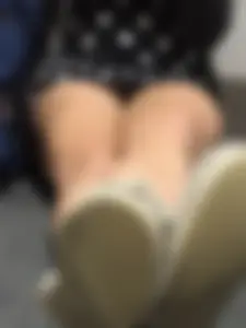 Girl in a Dress Sitting on the Floor With Crossed Legs
