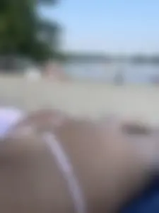 Awesome booty in strings at the beach closeup