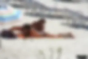 Topless milf and her topless daughter on the beach