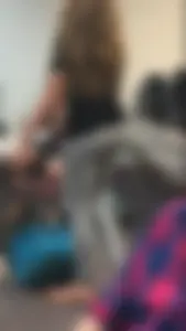 Skinny college girl in grey leggings in class