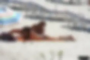 Topless milf and her topless daughter on the beach