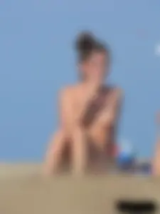 Sexy babe with a nice body topless and in a thong on the beach