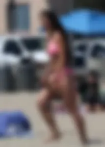 Sexy brunette on the beach in a bikini with great tits