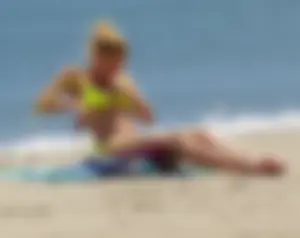 Sexy ass blonde milf on the beach in a thong with cameltoe and bending over