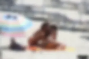Topless milf and her topless daughter on the beach