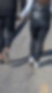 A beautiful little brunette walking in the park. tight black leggings