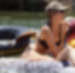 Sexy party girls in bikinis on a lake