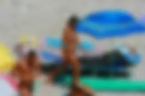 Nudist couple on the beach, girl has amazing tits and nice ass in a thong