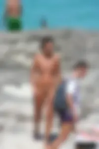 Older lady on a nude beach showing her body