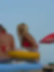Sexy mom and daughter in red thongs at the beach