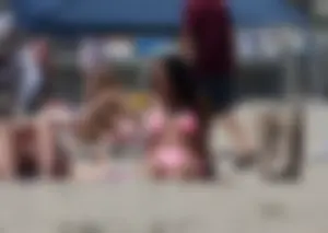 Sexy brunette on the beach in a bikini with great tits