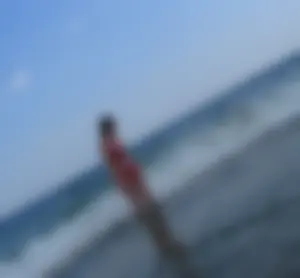 Sexy girl at the beach in a red thong bikini with nice tits and ass
