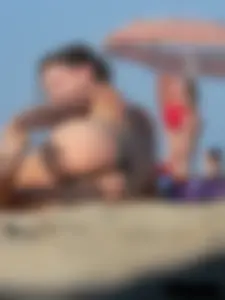 Sexy babe with a nice body topless and in a thong on the beach