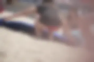 A group of teens in bikinis on the beach