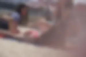 A group of teens in bikinis on the beach