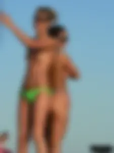 Bunch of sexy babes on the beach topless and in thong bikinis
