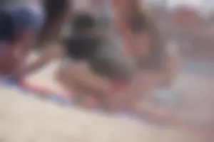 A group of teens in bikinis on the beach