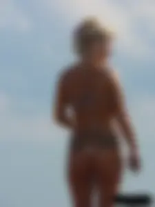 Tattooed blonde with big tits topless and in thong