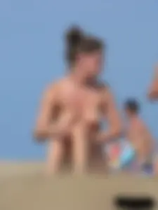 Sexy babe with a nice body topless and in a thong on the beach
