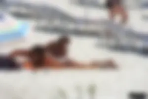 Topless milf and her topless daughter on the beach