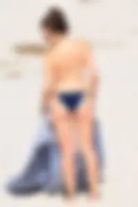 Blue bikini girl on the beach with a great ass and a little pussy lips slips