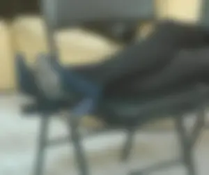 Candid College Teen in a Skirt, Black Pantyhose And High-Heeled Shoes Sitting With Her Crossed Slim Legs Put on a Chair Creepshot