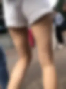 Hot Candid Girl in a Top, Shorts and Sneakers Skinny Legs Closeup Creepshots Gallery on the City Street