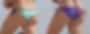 Cute girls in light blue and purple bikinis on the beach