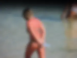Blonde milf on the beach in her bikini