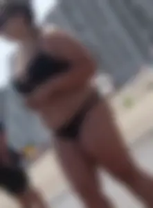 Thick beach girl in black bikini with big ass and tits