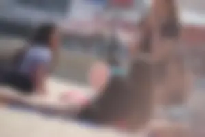 A group of teens in bikinis on the beach