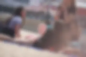 A group of teens in bikinis on the beach