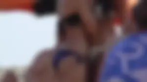 Sexy beach girl in a purple bikini bottom with a nice ass and bonus sexy friends