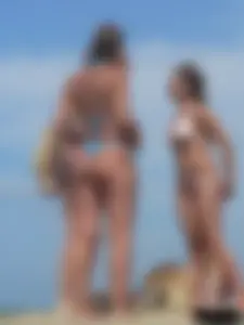 Sexy lady on the beach in a blue thong bikini