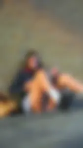 Girl Sitting on the Floor in a Skirt Revealing Panties While Standing Up