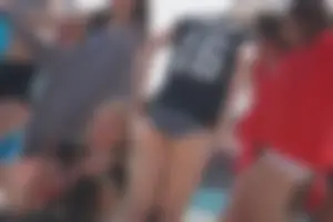 A group of teens in bikinis on the beach