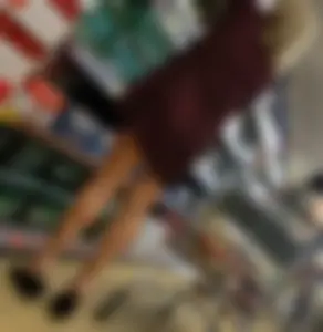 Girl With Skinny Legs Standing on Tiptoes Revealing Bare Feet at the Supermarket