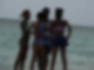 Candid black family, milf and teens on the beach in bikinis
