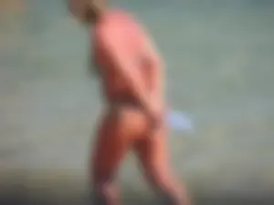 Blonde milf on the beach in her bikini