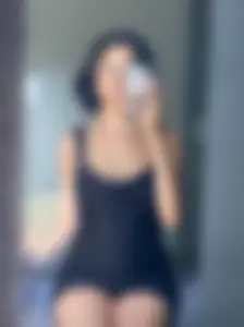 Cute Girl in Short Dress Sitting on Bed Mirror Selfie