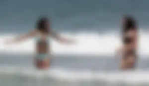 Brunette and redhead on the beach in bikinis looking sexy