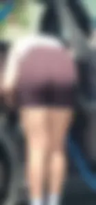 Yummy MILF @ carwash bent over in spandex shorts