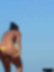 Bunch of sexy babes on the beach topless and in thong bikinis