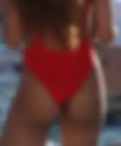 Sexy black girl in red swimsuit at the pool with side boob and a nice ass