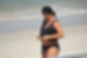 Blonde and brunette on the beach looking sexy in their bikinis