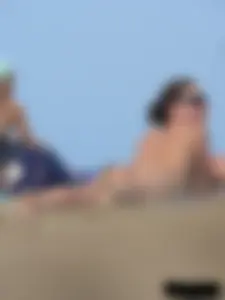 Sexy babe with a nice body topless and in a thong on the beach
