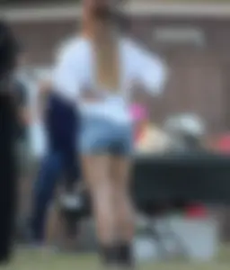 Hippie type dressed girl in denim shorts with a nice ass
