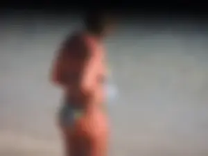 Blonde milf on the beach in her bikini