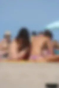 2 topless girls at the beach in thongs