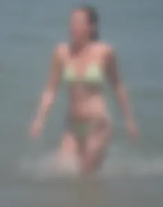 Milf at the beach in the water with hard nipples and a nice body